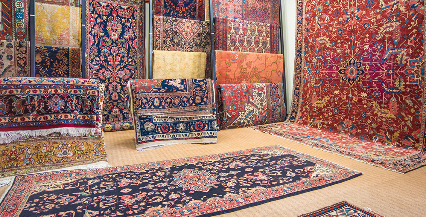 Aladdin Rug Gallery with numerous rugs displayed.