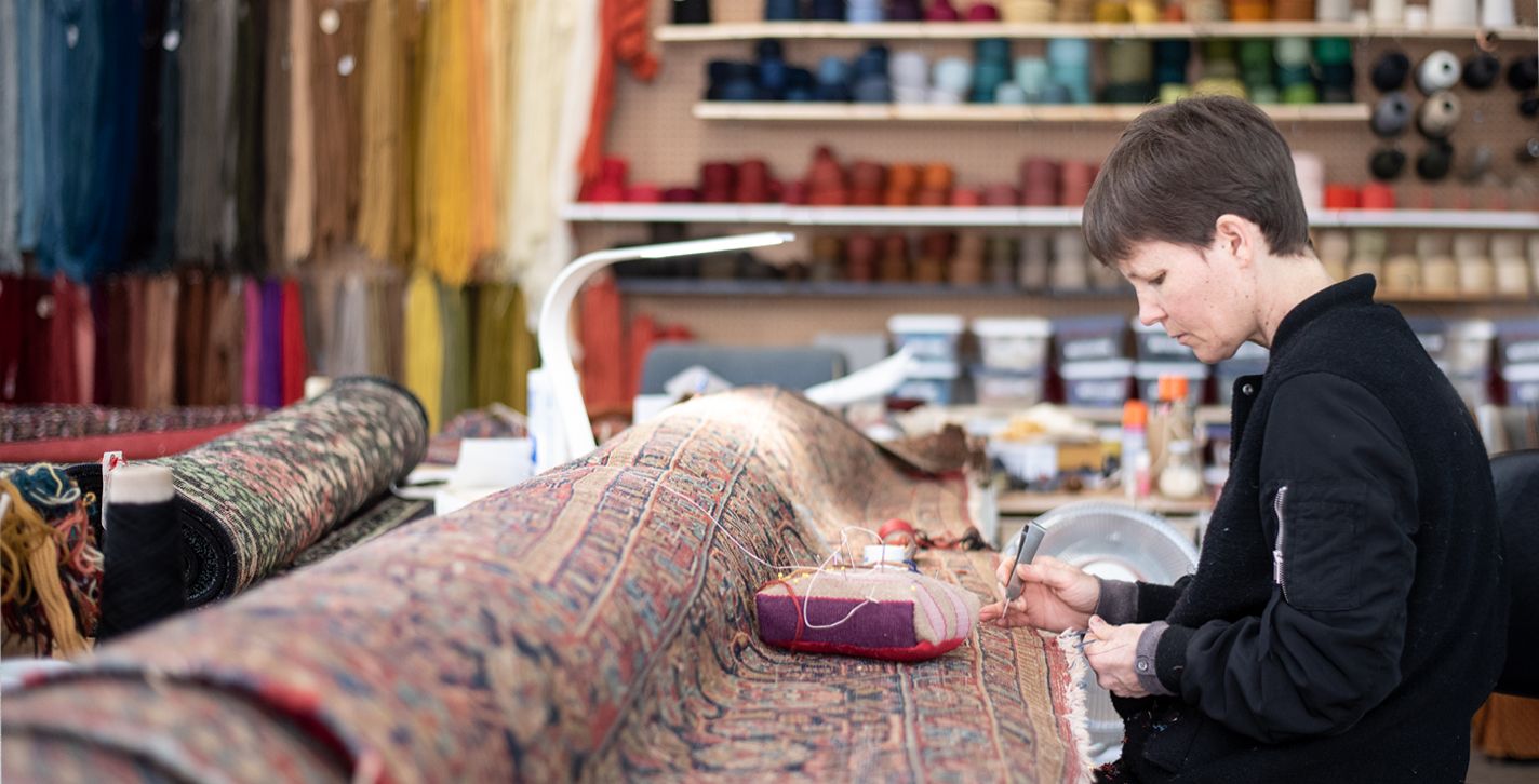 Aladdin Employee repairing rug. Aladdin Employee repairing rug.