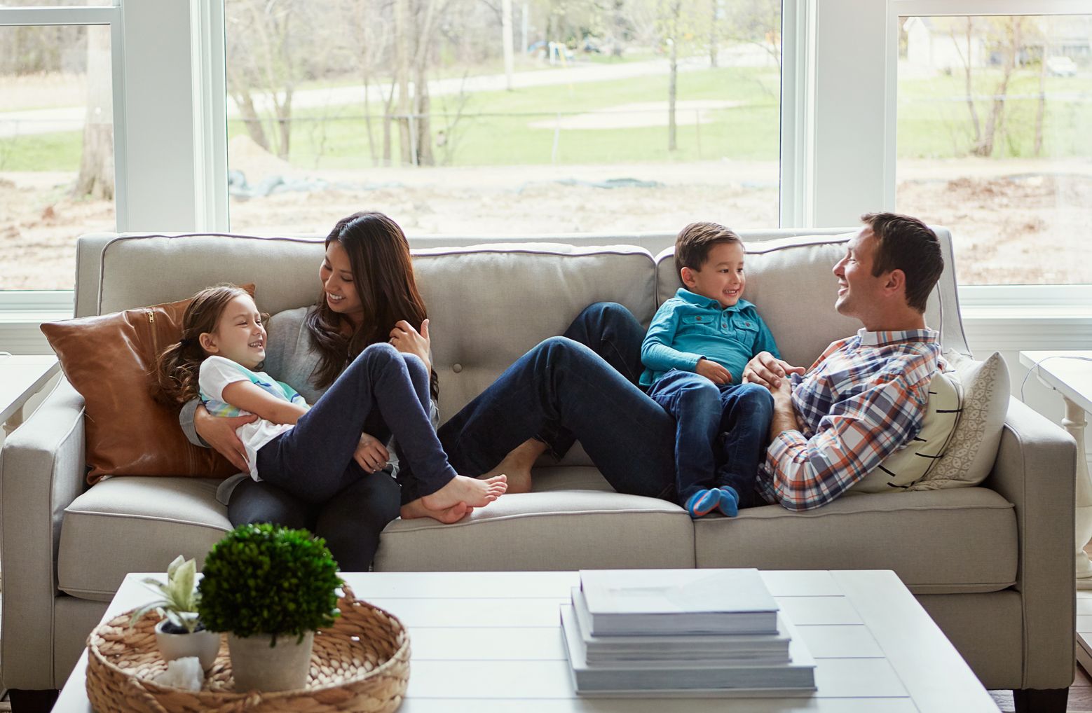 family-playing-together-clean-home Family sitting on couch in home