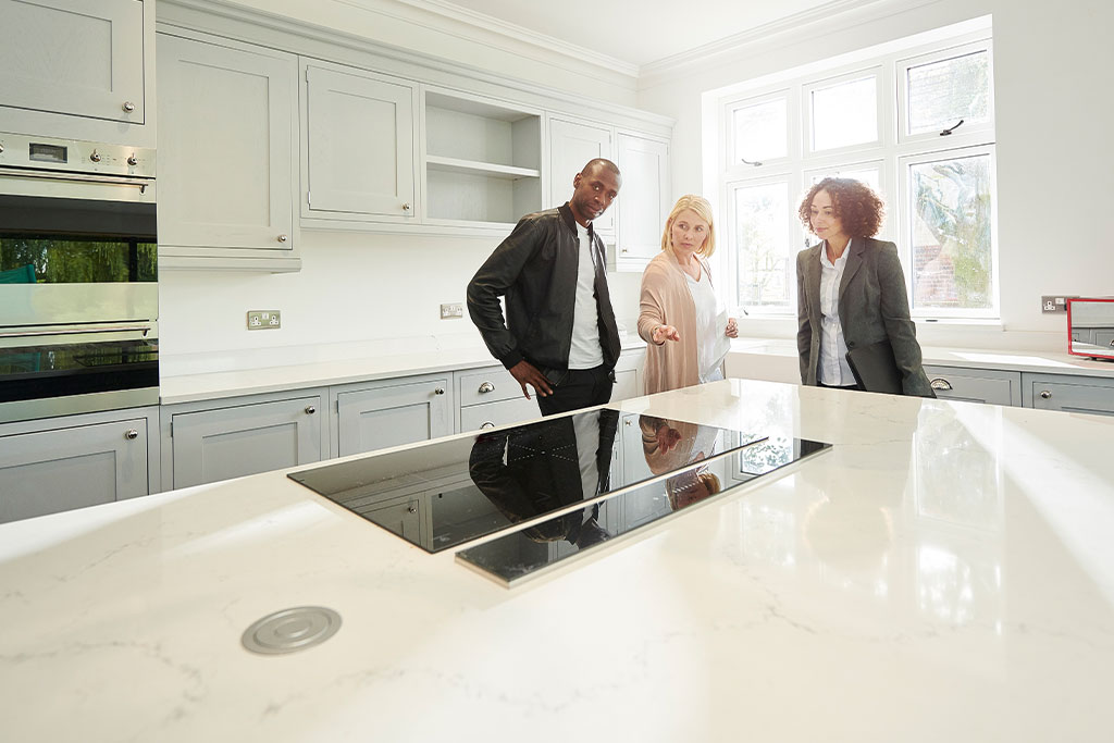 affiliate presenting kitchen to potential home buyers
