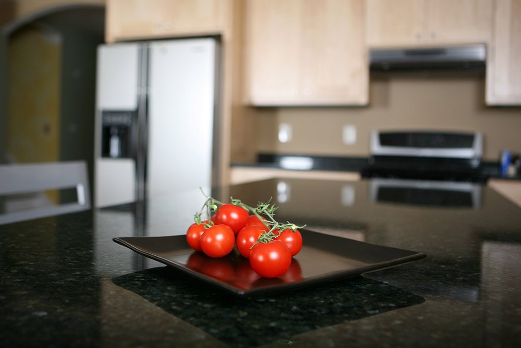 A kitchen with white marble counters that has been professionally cleaned by Aladdin Cleaning and Restoration