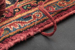 Antique oriental rug overcasting