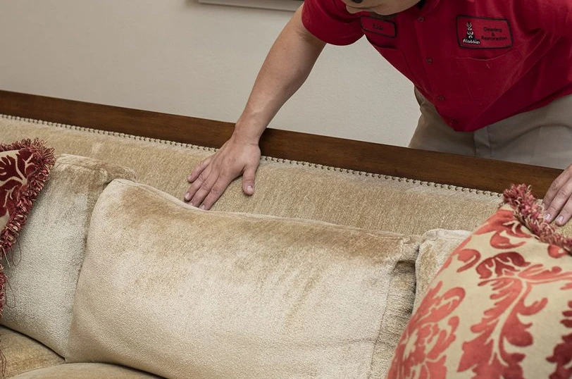 Aladdin employee pre-treating upholstery.